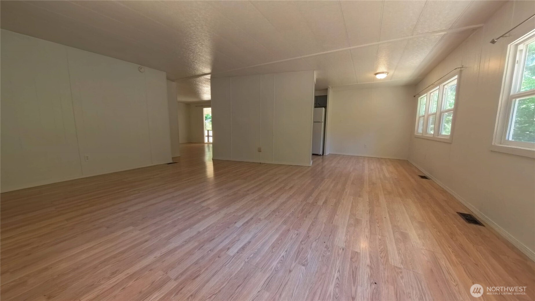 650 North Lake Cushman Road Hoodsport, WA 98548 - Photo 7 of 15 an empty room with wooden floor and windows