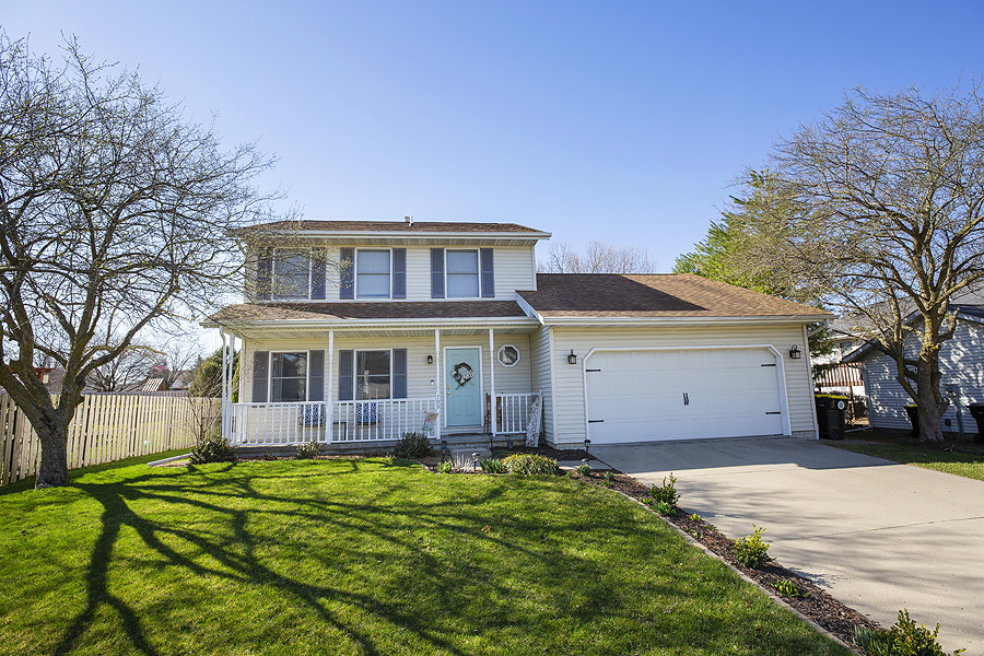 709 Landau Lane Normal, IL 61761 - Photo 1 of 44 a front view of a house with a yard and potted plants