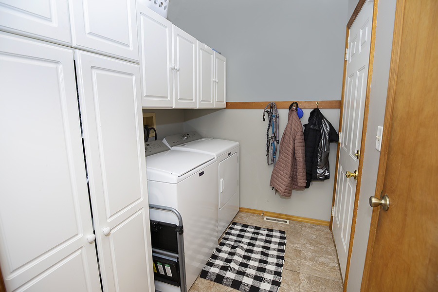 709 Landau Lane Normal, IL 61761 - Photo 14 of 44 a walk in closet with wooden floor
