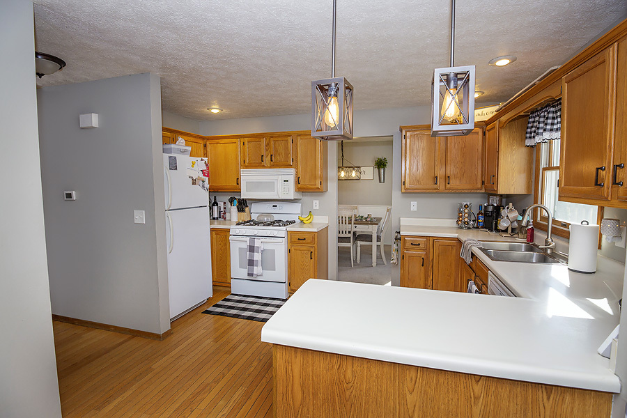 709 Landau Lane Normal, IL 61761 - Photo 21 of 44 a kitchen with sink a refrigerator and wooden floor
