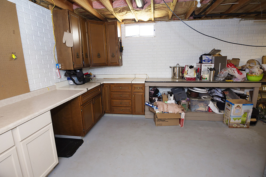 709 Landau Lane Normal, IL 61761 - Photo 26 of 44 a storage room with lots of clutter and cabinets