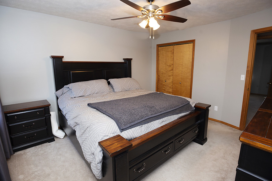 709 Landau Lane Normal, IL 61761 - Photo 32 of 44 a bedroom with a bed and a tv on a dresser