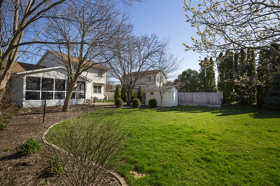 709 Landau Lane Normal, IL 61761 - Photo 38 of 44 a front view of a house with a garden and trees