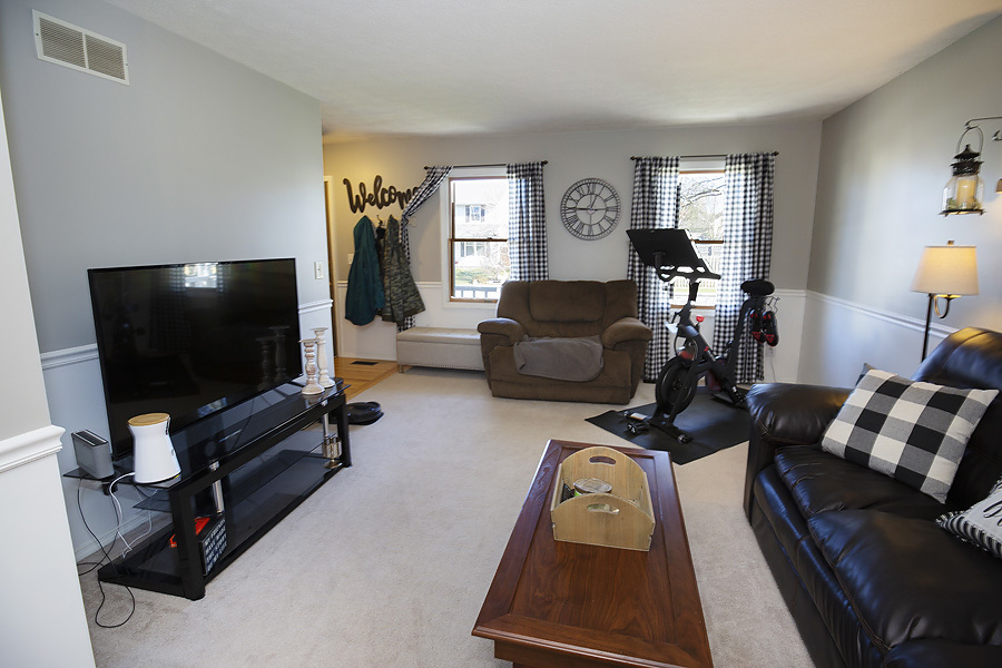 709 Landau Lane Normal, IL 61761 - Photo 7 of 44 a living room with furniture and a flat screen tv
