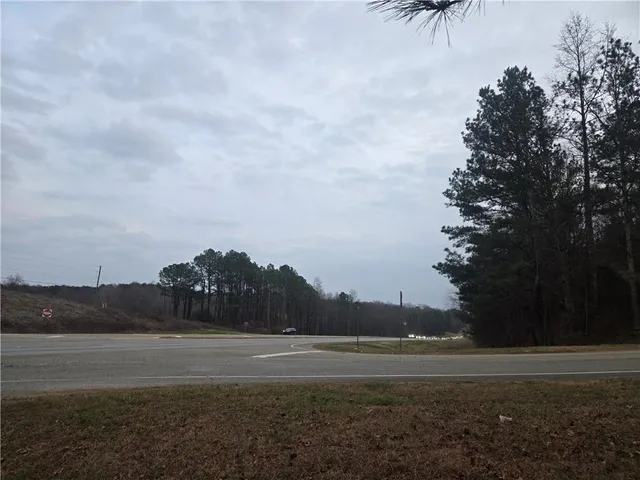 a view of mountain with sunset in background