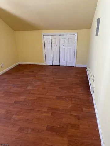 an empty room with wooden floor