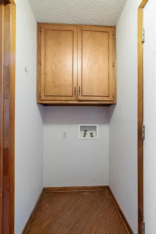 a view of room with wooden floor and cabinet