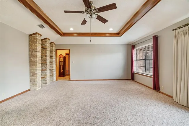 a view of empty room with ceiling fan