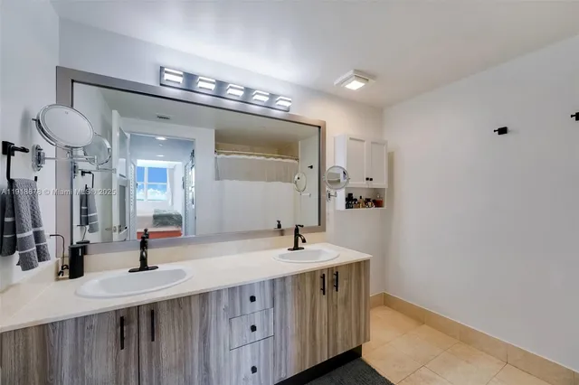 a bathroom with a double vanity sink and a mirror