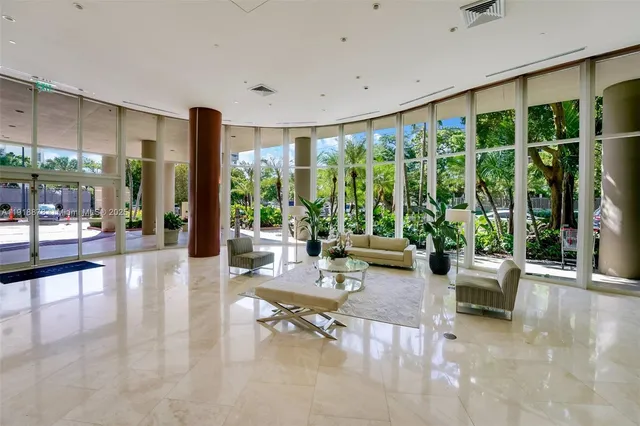 a living room with furniture and large windows