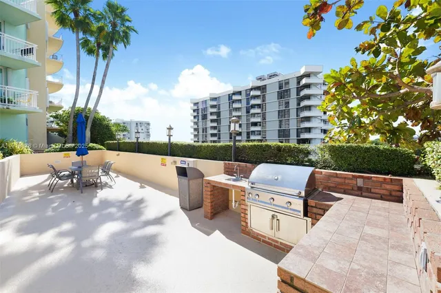 a view of a patio with a table and chairs