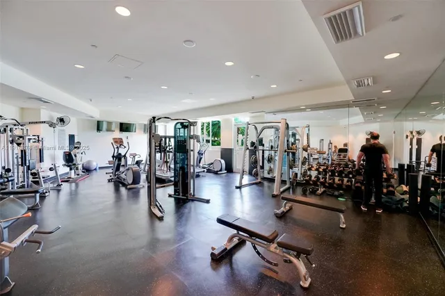 a view of a room with gym equipment and lots of equipment