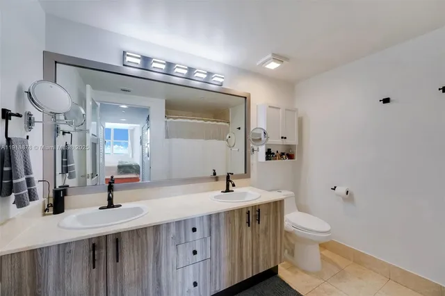 a bathroom with 2 sink and a mirror