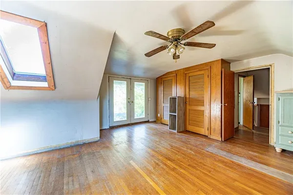 a view of a livingroom with wooden floor and window