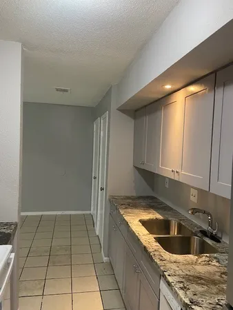 a kitchen with a sink and cabinets