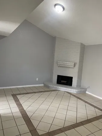 a view of an empty room and fire place