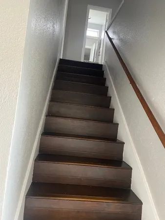 en empty room with wooden floor and windows