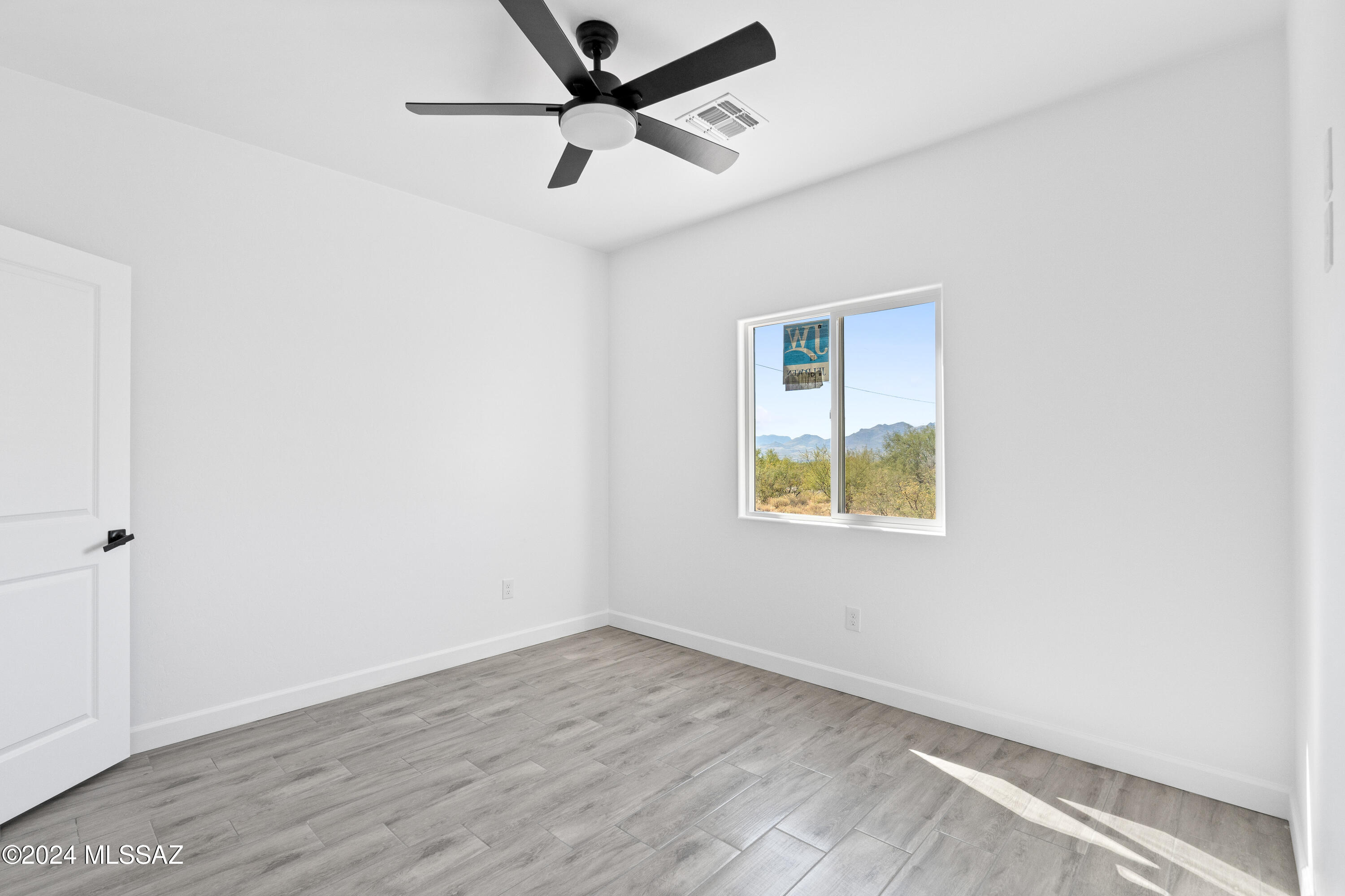 1874 Circulo Colombia Rio Rico, AZ 85648 - Photo 22 of 31 an empty room with a window and a ceiling fan