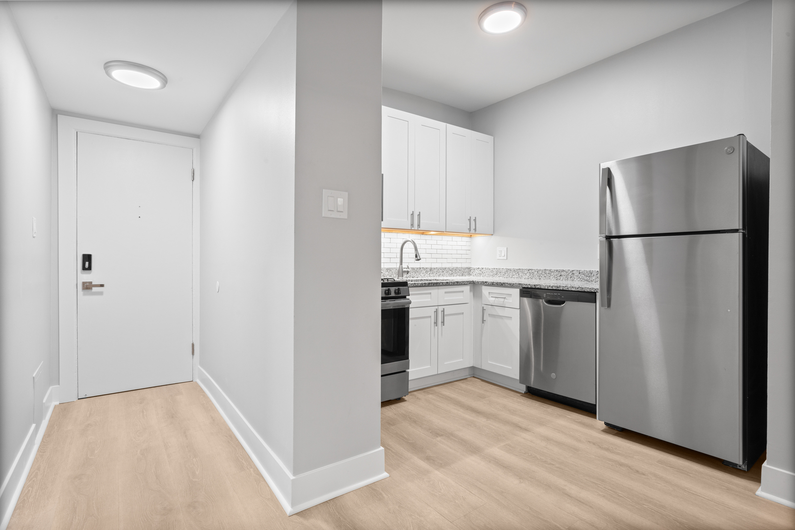 7600 North Sheridan Road, Unit 107 Chicago, IL 60626 - Photo 2 of 9 a kitchen with a refrigerator sink and cabinets