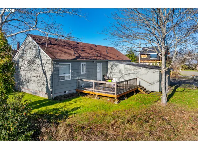 a small house with a large tree in front of it