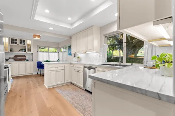 a kitchen with sink cabinets and window