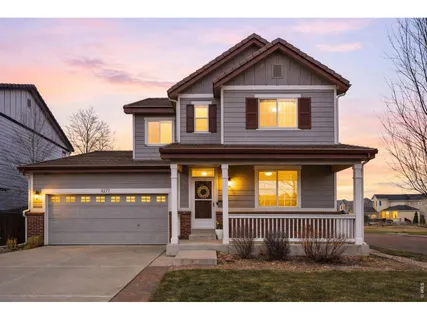 a view of a house with a small yard and a large window