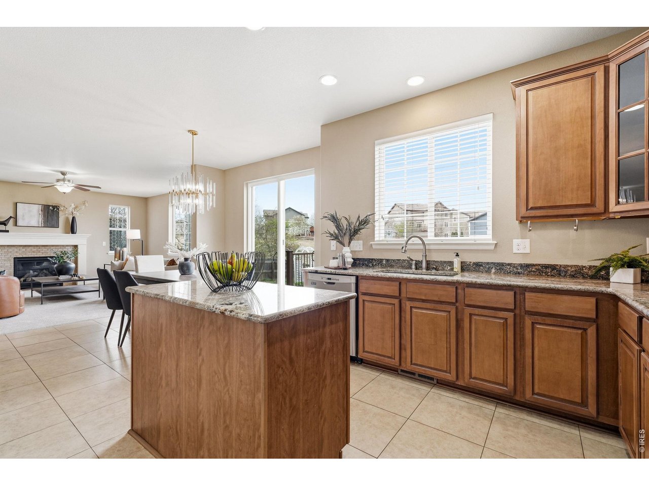 1277 Mathews Way Erie, CO 80516 - Photo 14 of 40 a kitchen with stainless steel appliances granite countertop a sink counter space windows and a living room view