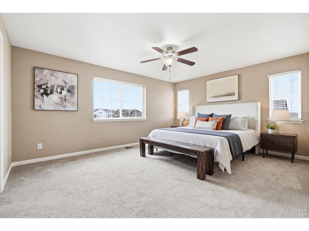 1277 Mathews Way Erie, CO 80516 - Photo 15 of 40 a bedroom with a bed and a chandelier
