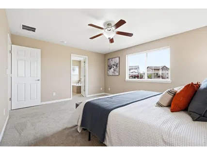 a bedroom with a bed and window