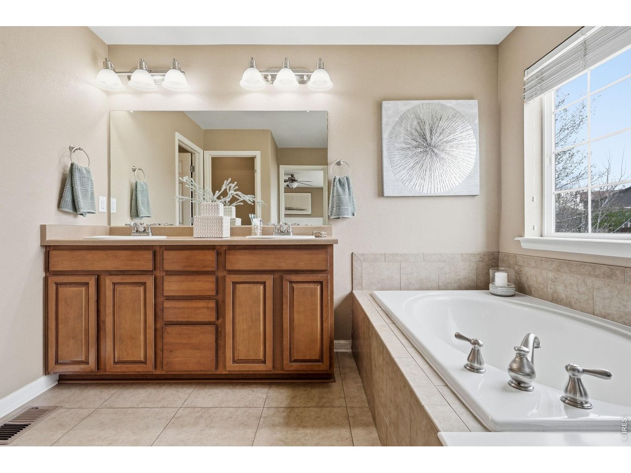 1277 Mathews Way Erie, CO 80516 - Photo 19 of 40 a bathroom with a tub a sink and a large mirror