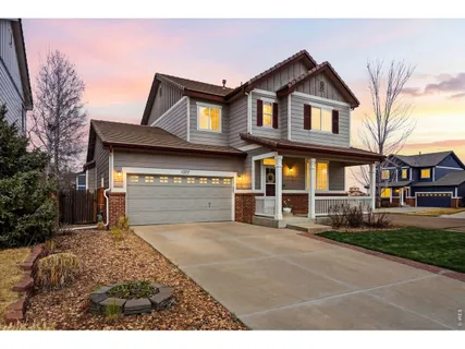 a view of a house with a yard and pathway