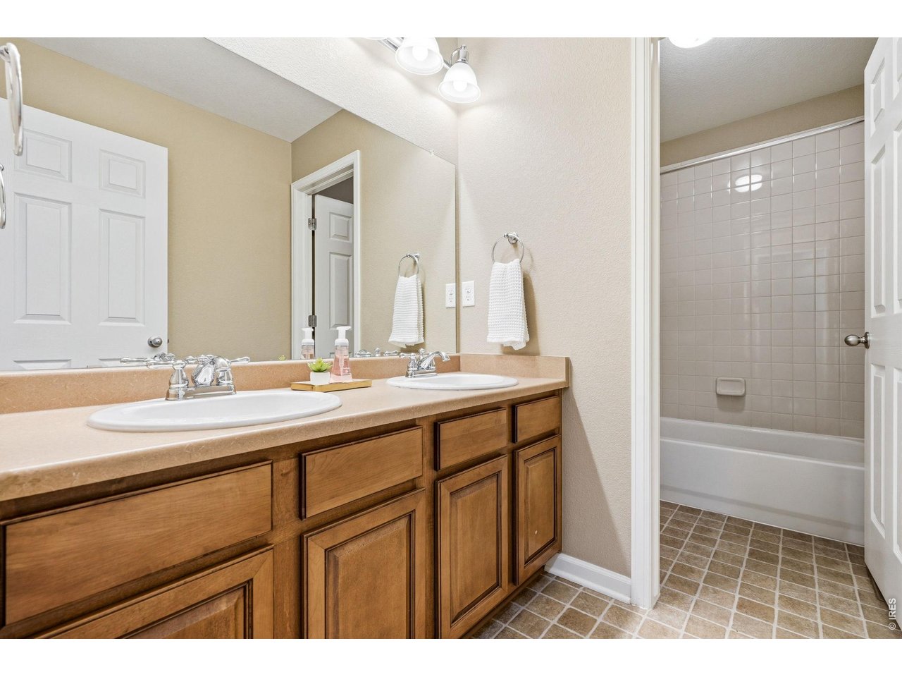 1277 Mathews Way Erie, CO 80516 - Photo 26 of 40 a bathroom with a sink a mirror and a bathtub