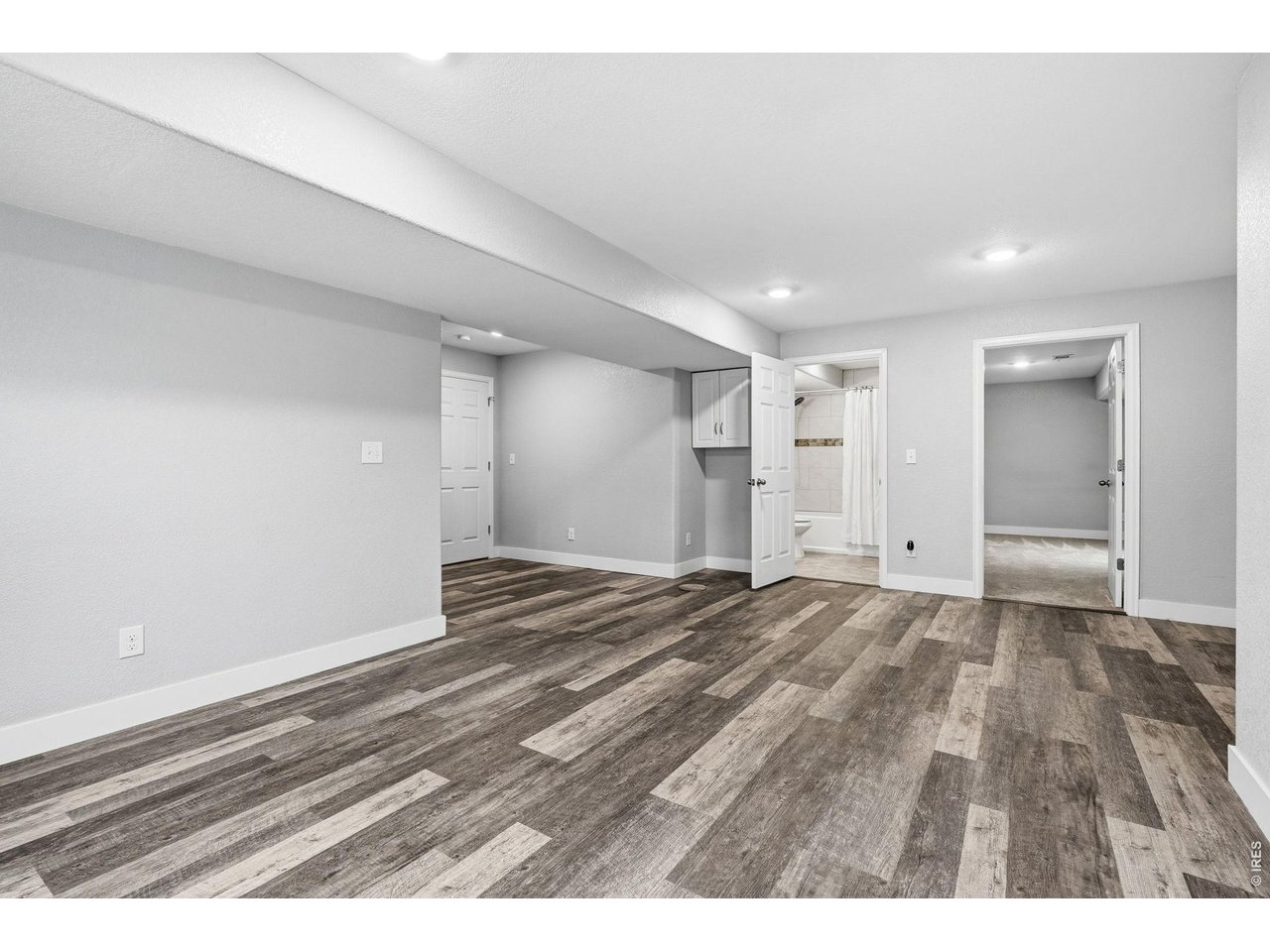 1277 Mathews Way Erie, CO 80516 - Photo 28 of 40 a view of an empty room and wooden floor