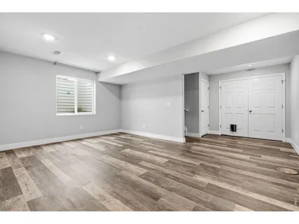 a view of an empty room and wooden floor