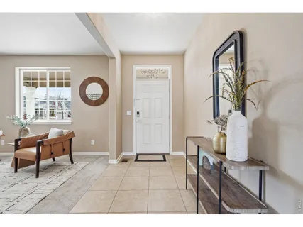 a living room with furniture a window and a clock