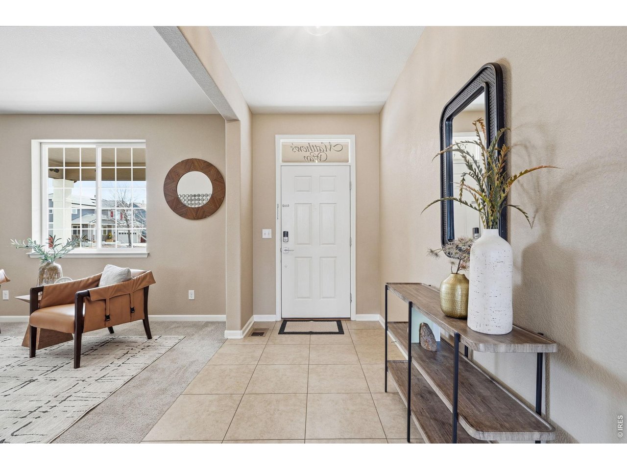 1277 Mathews Way Erie, CO 80516 - Photo 4 of 40 a living room with furniture a window and a clock