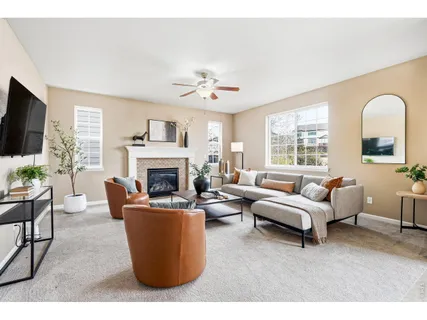a living room with furniture a fireplace and a flat screen tv