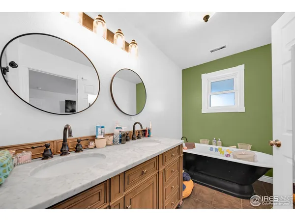 a bathroom with a double vanity sink and a mirror