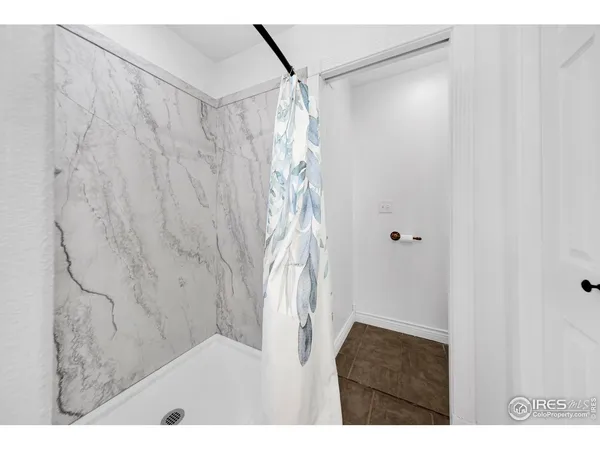a bathroom with a shower curtain and a sink