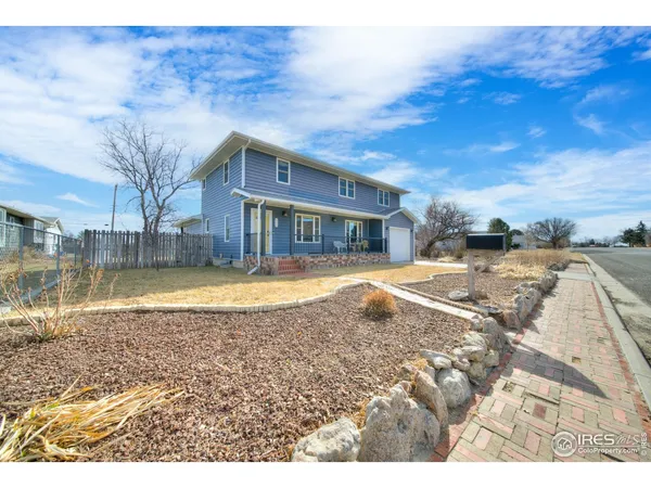 a view of pool with large trees and wooden fence