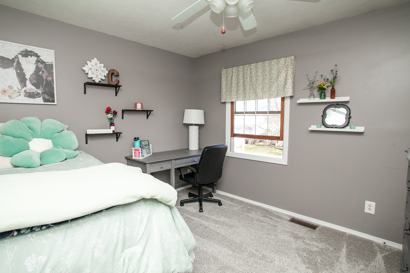 1308 Mill Creek Road Bloomington, IL 61704 - Photo 21 of 26 a bedroom with a bed and a chandelier