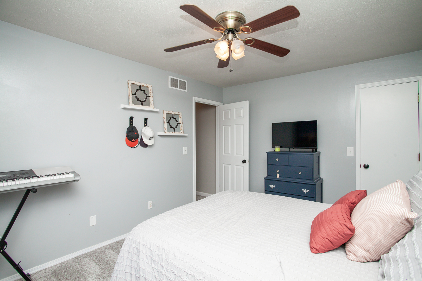 1308 Mill Creek Road Bloomington, IL 61704 - Photo 22 of 26 a bedroom with a bed and a flat screen tv