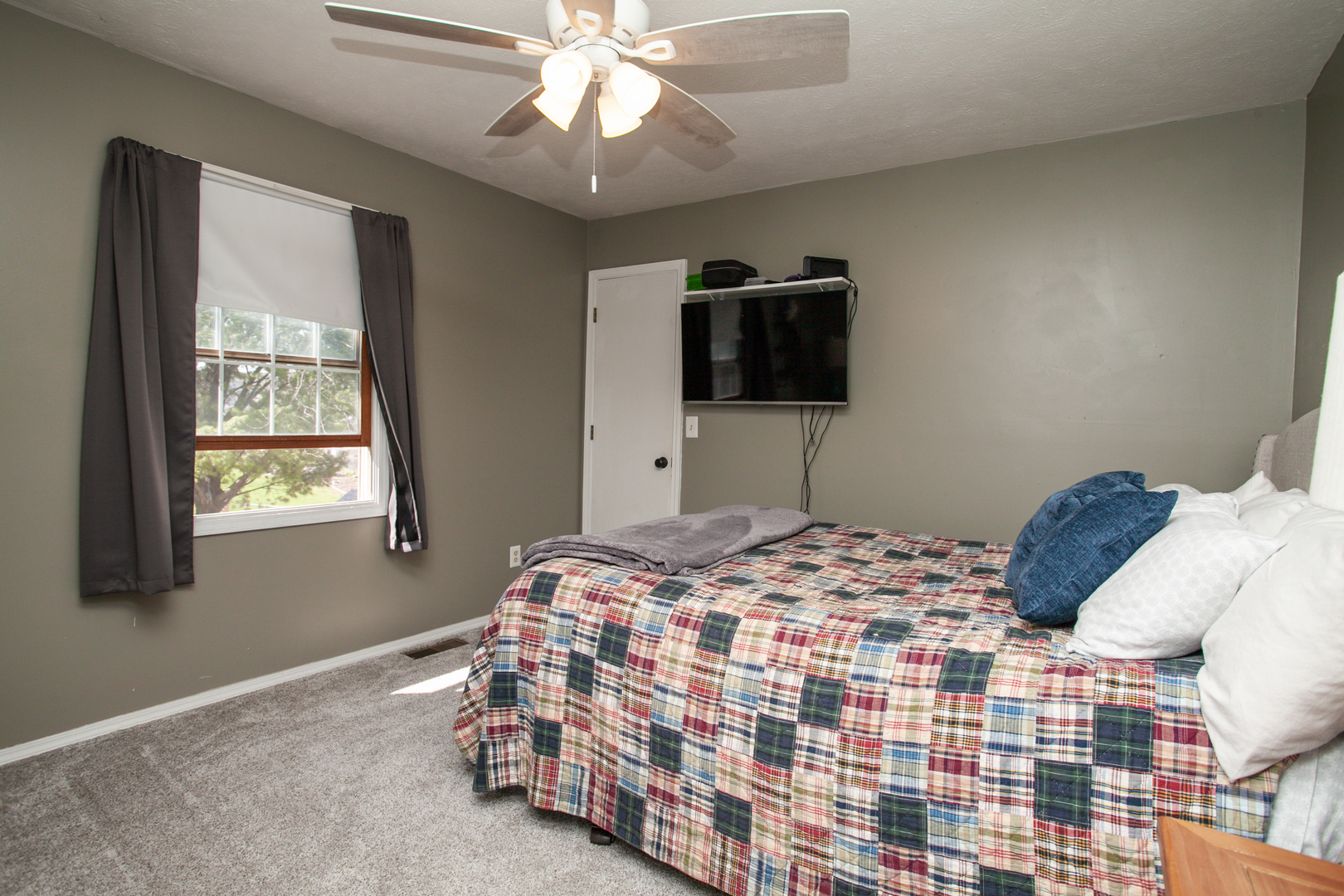 1308 Mill Creek Road Bloomington, IL 61704 - Photo 24 of 26 a bedroom with a bed and a flat screen tv