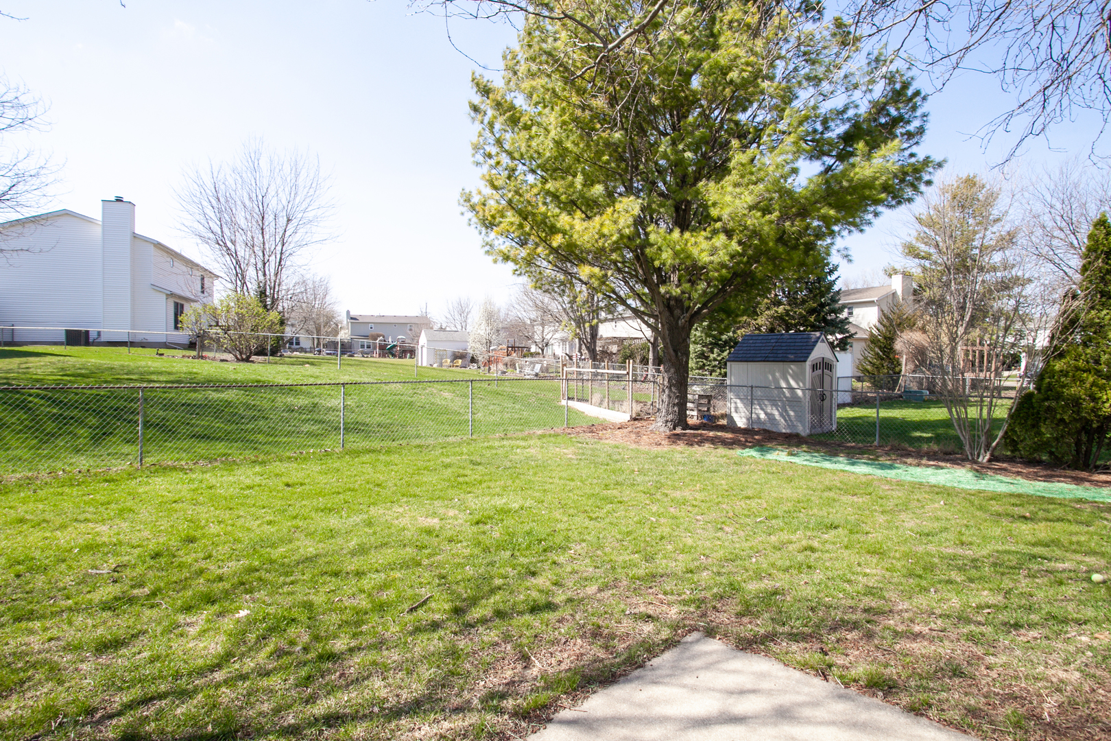 1308 Mill Creek Road Bloomington, IL 61704 - Photo 4 of 26 a backyard of a house with lots of green space