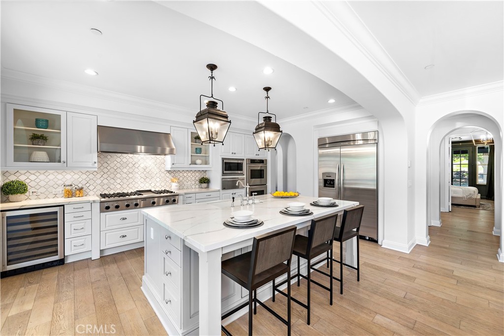 2 Anna Lane Ladera Ranch, CA 92694 - Photo 12 of 63 a kitchen with stainless steel appliances a stove a sink a dining table and chairs