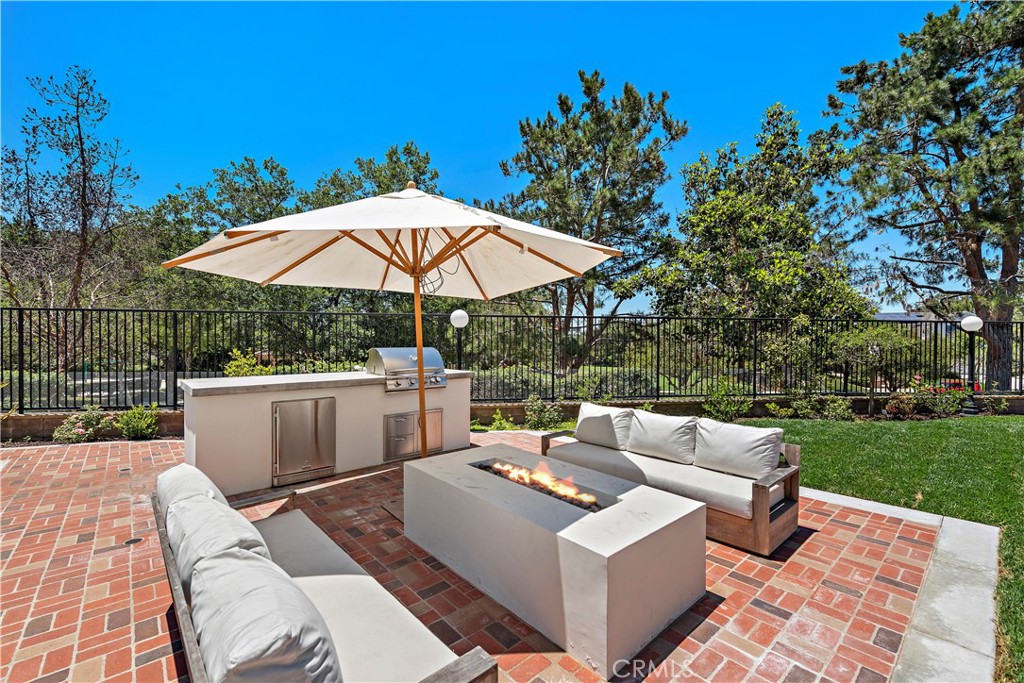 2 Anna Lane Ladera Ranch, CA 92694 - Photo 35 of 63 a view of a patio with couches and a table and chairs under an umbrella