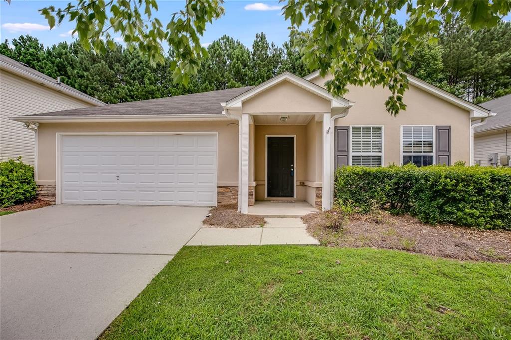 a front view of a house with a yard and garage
