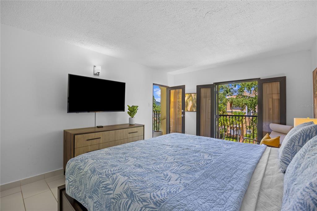 2066 Montesol, Unit 2066 Humacao, PR 00792 - Photo 13 of 29 a bedroom with a bed and a flat screen tv