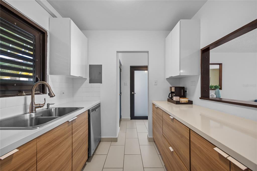2066 Montesol, Unit 2066 Humacao, PR 00792 - Photo 16 of 29 a kitchen with stainless steel appliances granite countertop a sink stove and refrigerator