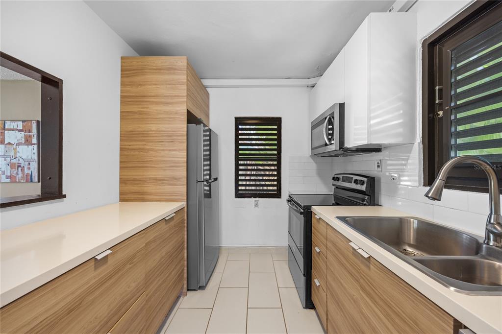 2066 Montesol, Unit 2066 Humacao, PR 00792 - Photo 17 of 29 a kitchen that has a sink and a stove